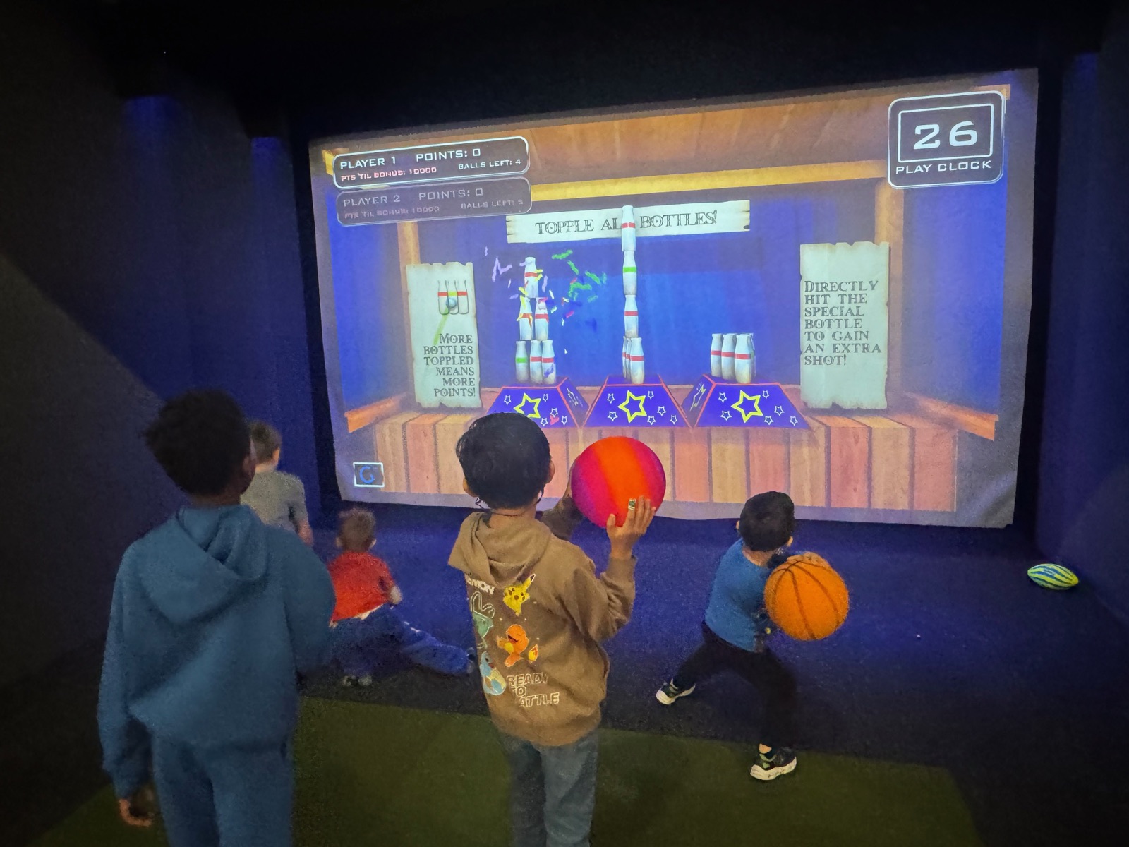 Kids playing interactive sports games at SWING
