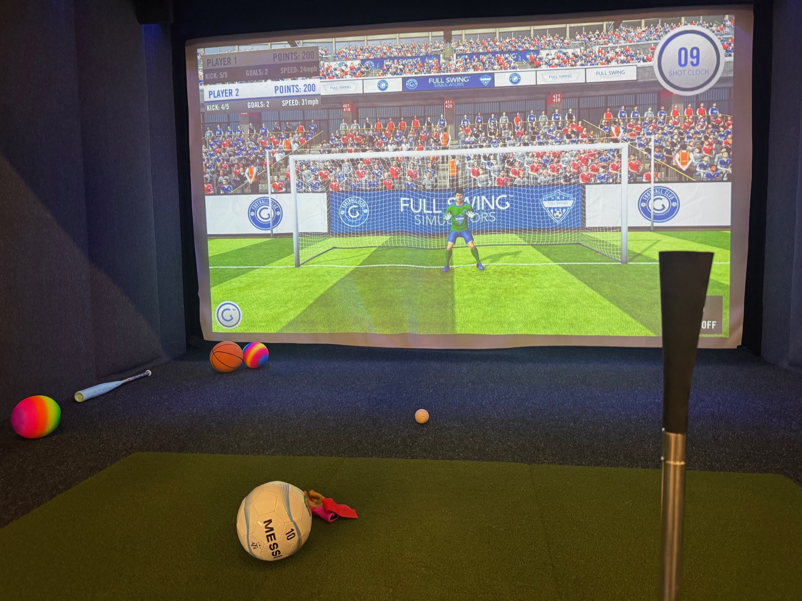Kids playing soccer on the interactive simulator during a party