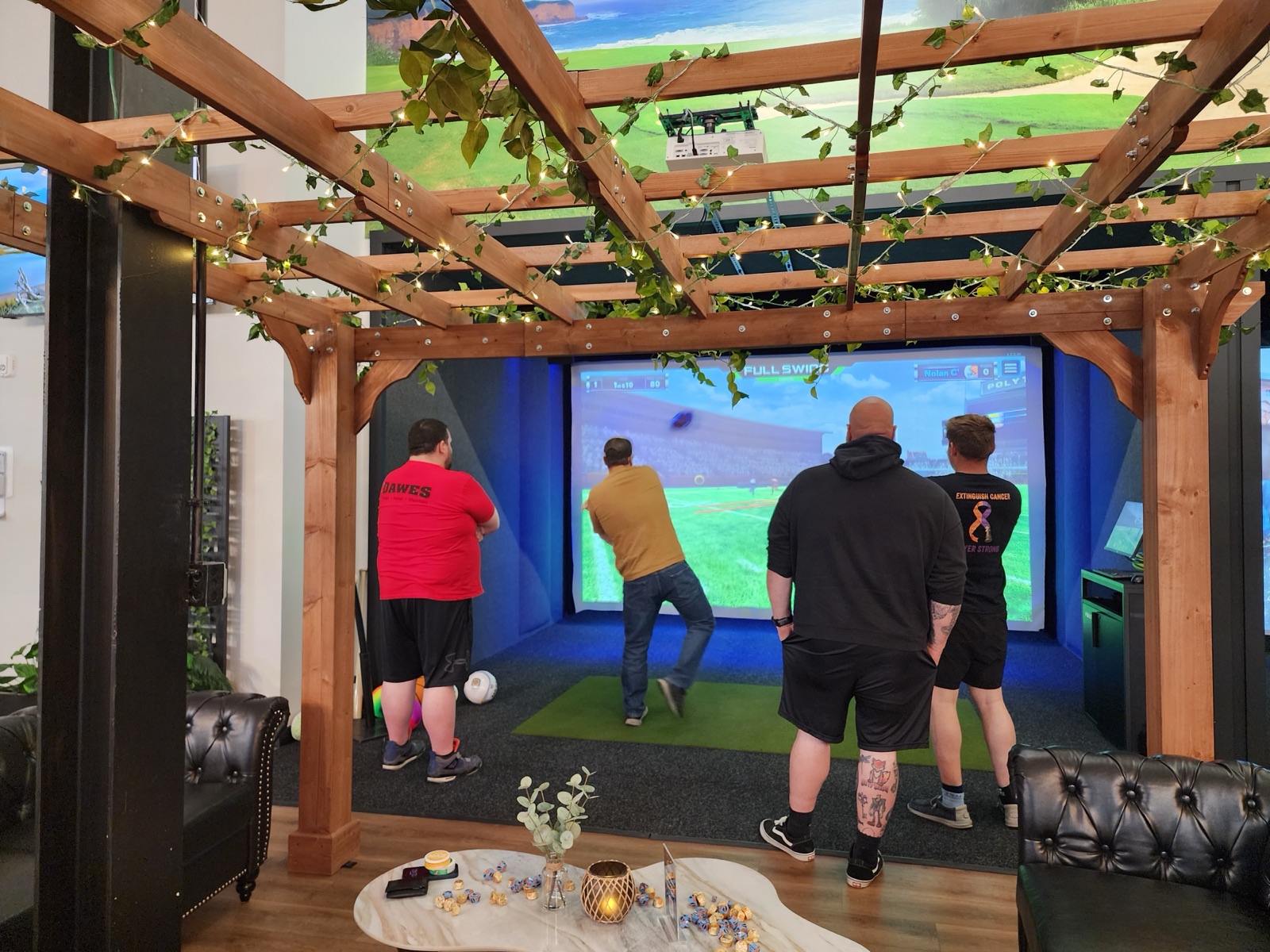Corporate group playing golf simulators