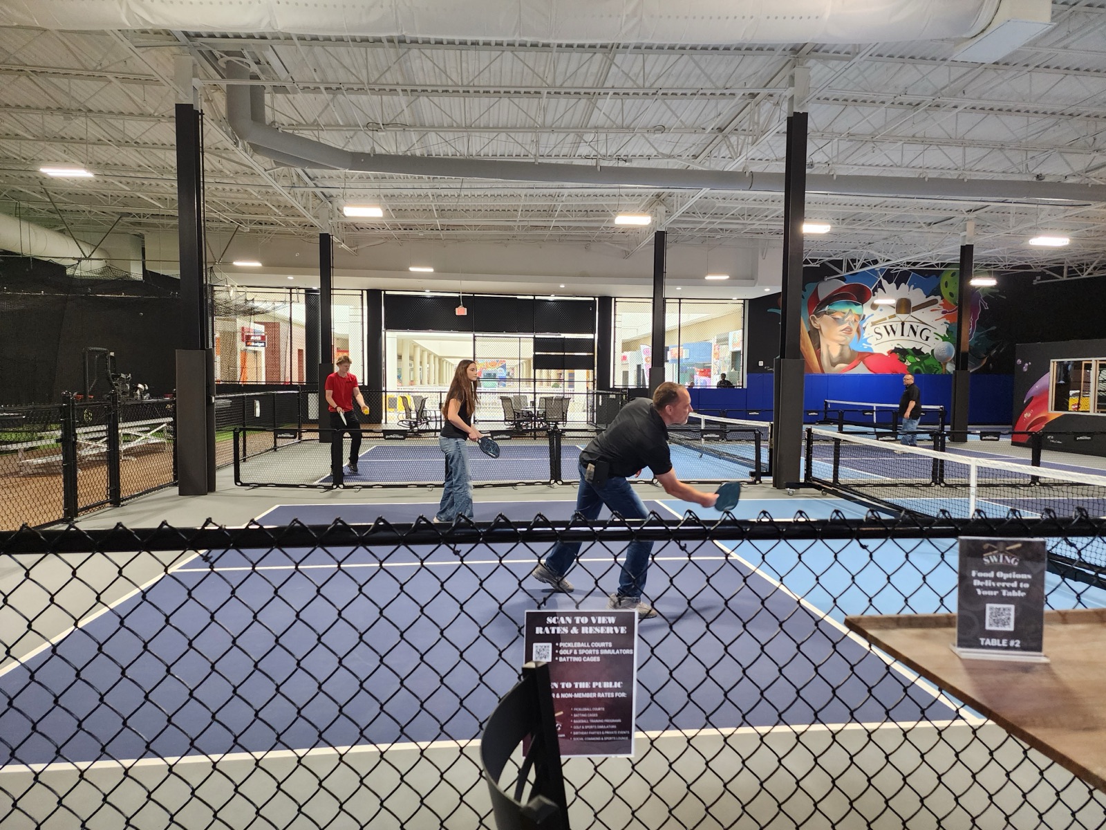 Employees playing pickleball during a corporate outing
